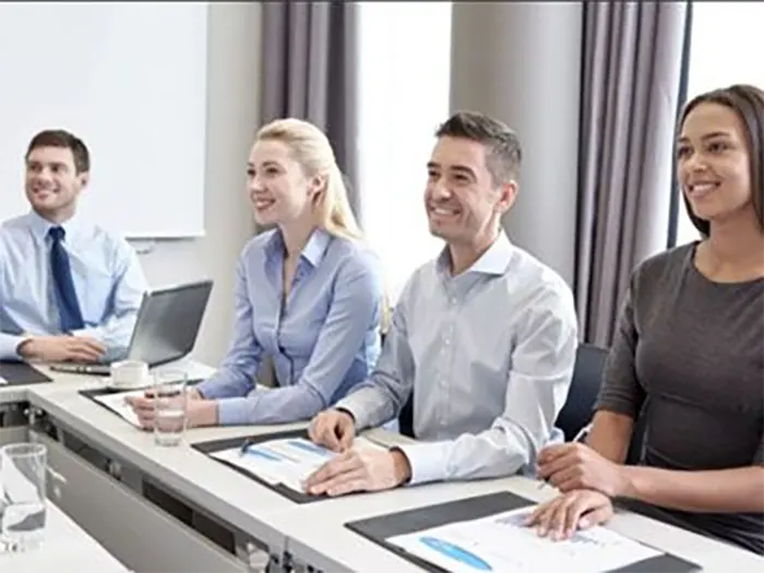 Ayqrufourbusinessprofessionalssittingataconferencetableparticipatinginameetingwithdocumentsonthetable